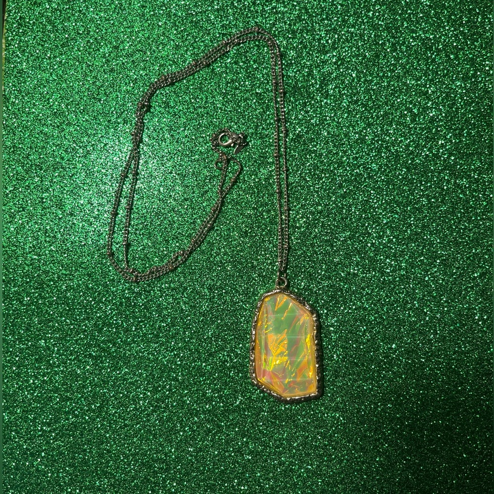 Yellow Faux Stone surrounded by gold tone rim